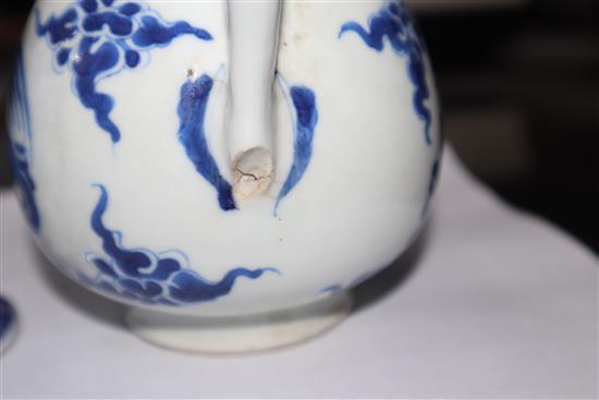 A Chinese Kangxi period blue and white wine pot and a Qianlong period helmet shaped milk jug Height of pot 16cm